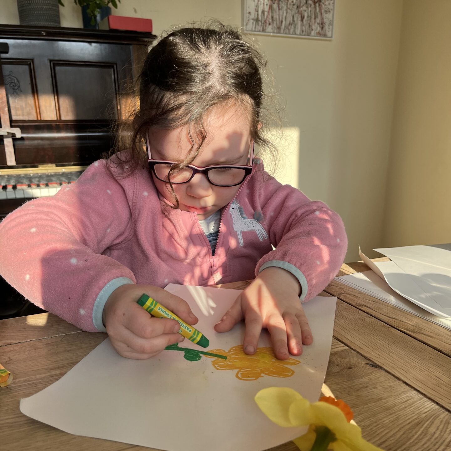 Spring has arrived - a girl drawing daffodils with oil pastels