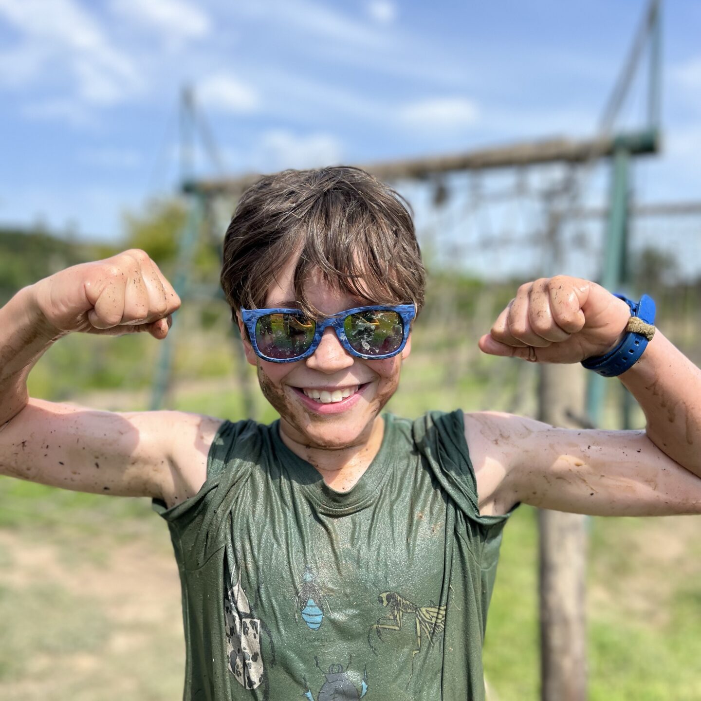 bear trail with a boy smiling covered in mud 
