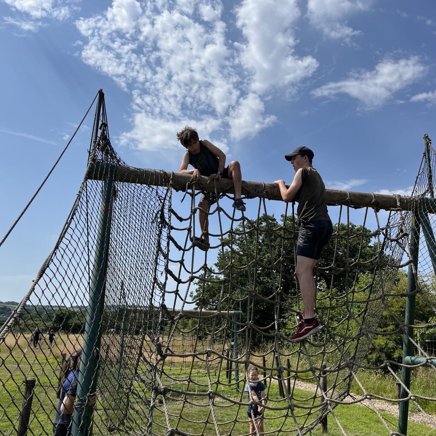 2 boys climbing an assault course at the bear trail 