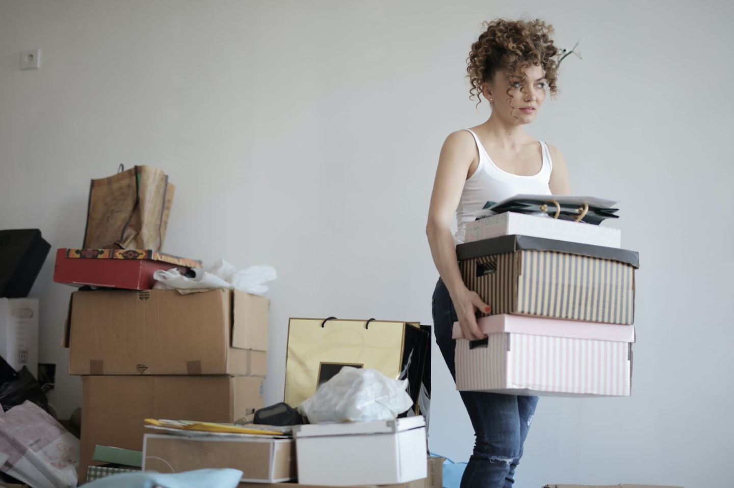 Home decluttering with a woman surrounded by boxes of admin and home items