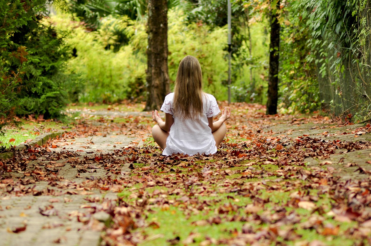 Unveiling the Holistic Approach of Prep Schools - a child with long hair sat meditating in the woods