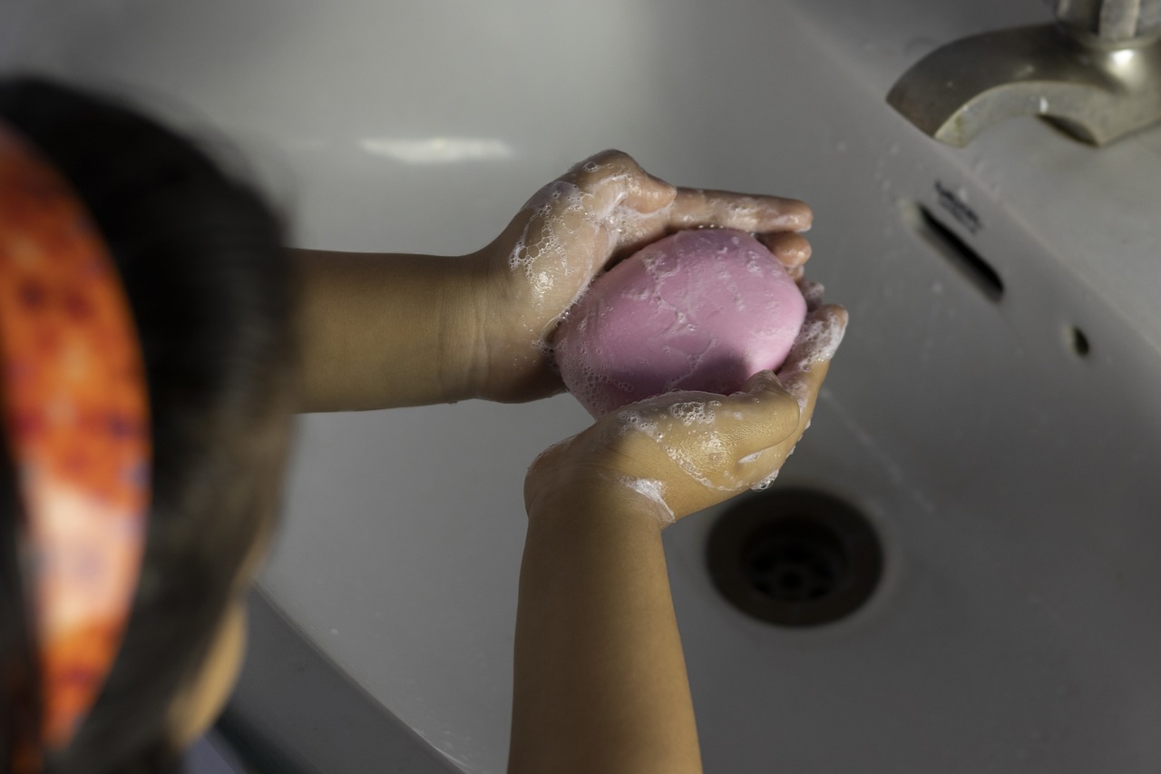 teaching your toddler about personal hygiene with a photo of a child washing their hands